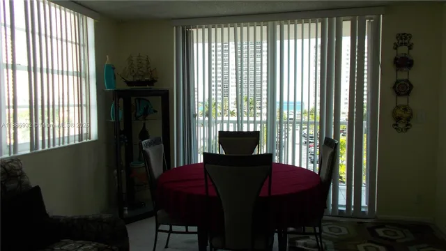 a view of a dining room with furniture and a window