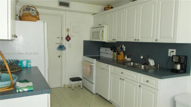 a kitchen with stainless steel appliances cabinets a sink and a counter top space