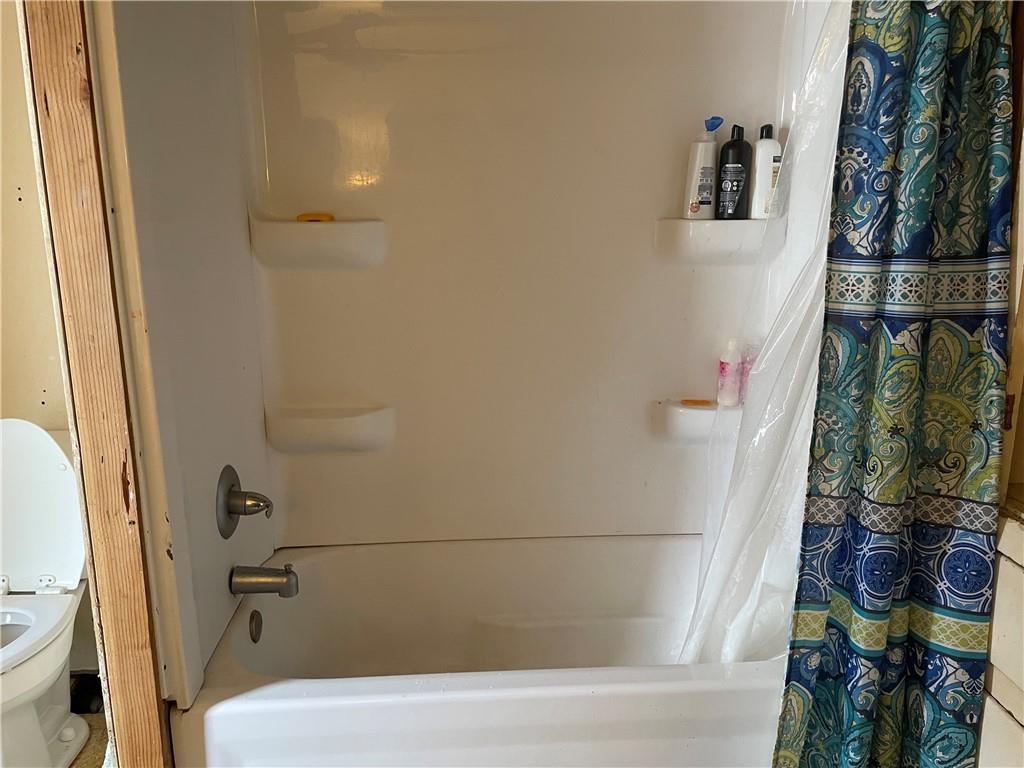 705 East Lutton Street New Castle, PA 16101 - Photo 15 of 23 a bathroom with a bathtub and a shower