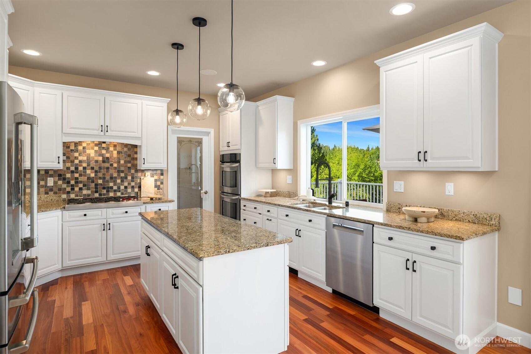 3129 115th Avenue Southeast Snohomish, WA 98290 - Photo 13 of 40 a kitchen with stainless steel appliances granite countertop a sink stove and refrigerator