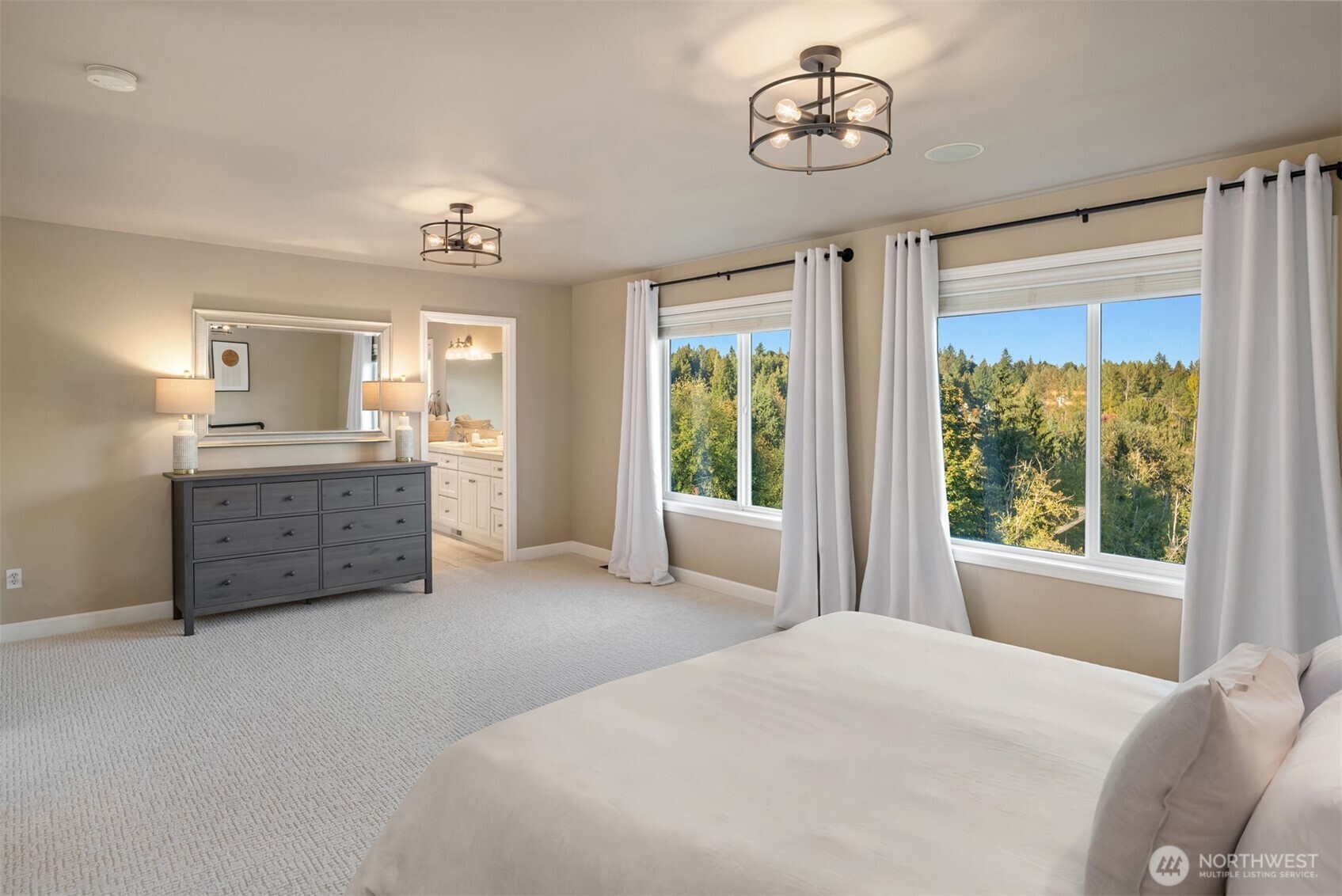 3129 115th Avenue Southeast Snohomish, WA 98290 - Photo 17 of 40 a spacious bedroom with a bed and a chandelier