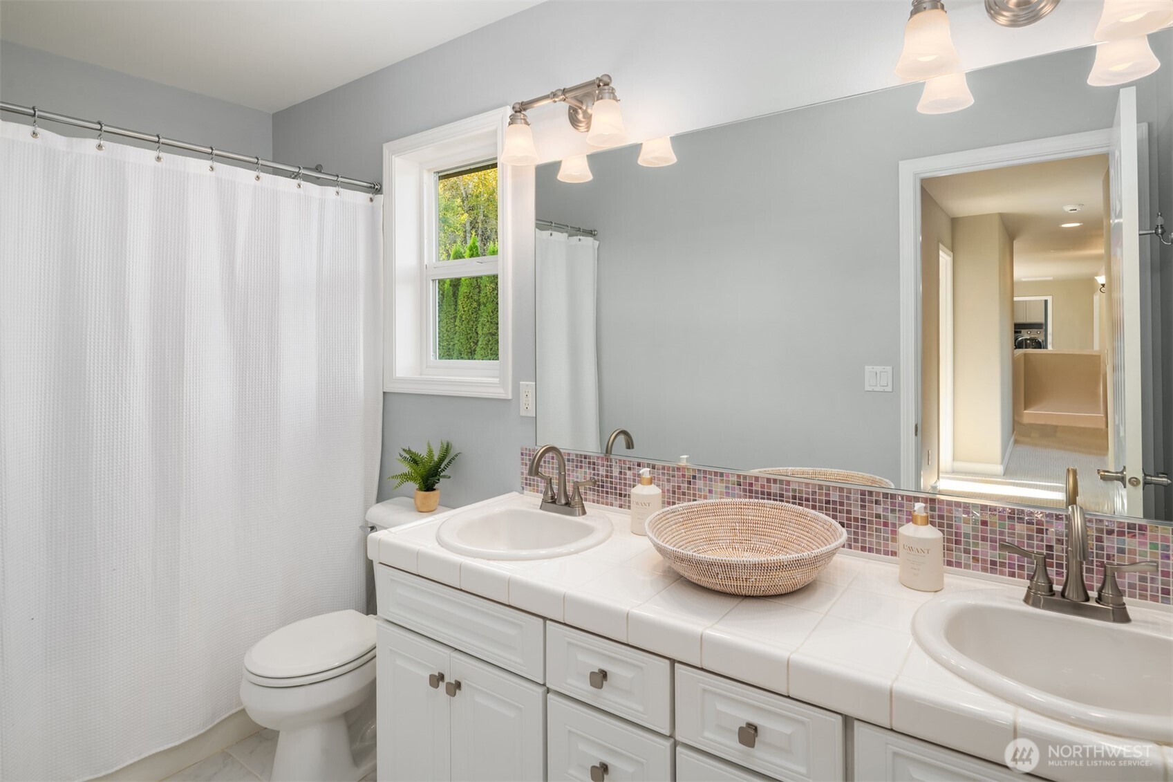 3129 115th Avenue Southeast Snohomish, WA 98290 - Photo 23 of 40 a bathroom with a granite countertop sink toilet and a mirror