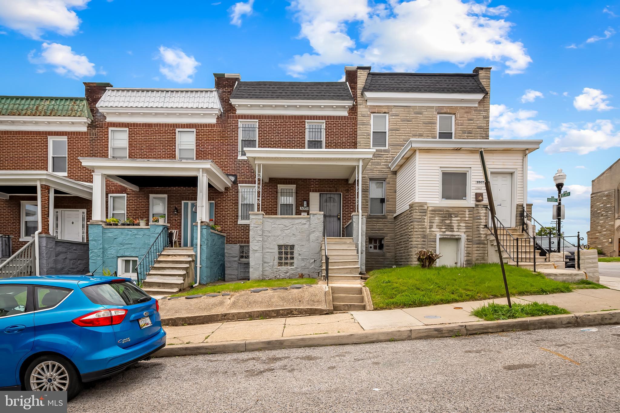 a front view of a house with a garden and parking