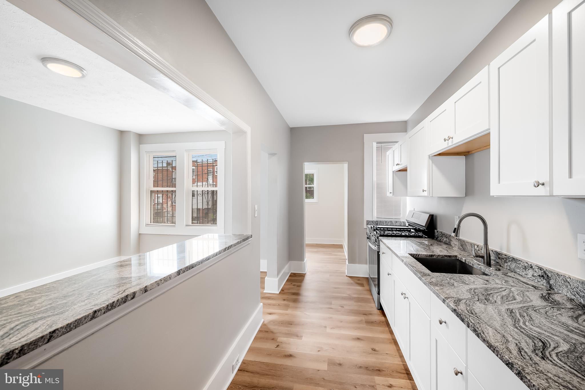 3003 Kentucky Avenue Baltimore, MD 21213 - Photo 12 of 32 a view of a kitchen with a sink and wooden floor