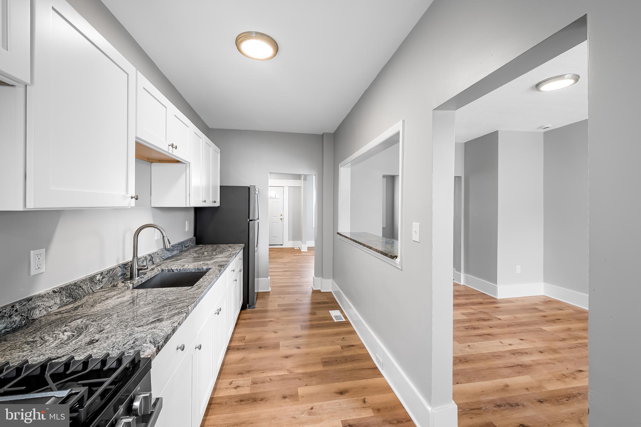 3003 Kentucky Avenue Baltimore, MD 21213 - Photo 14 of 32 a kitchen with granite countertop lots of counter top space and windows
