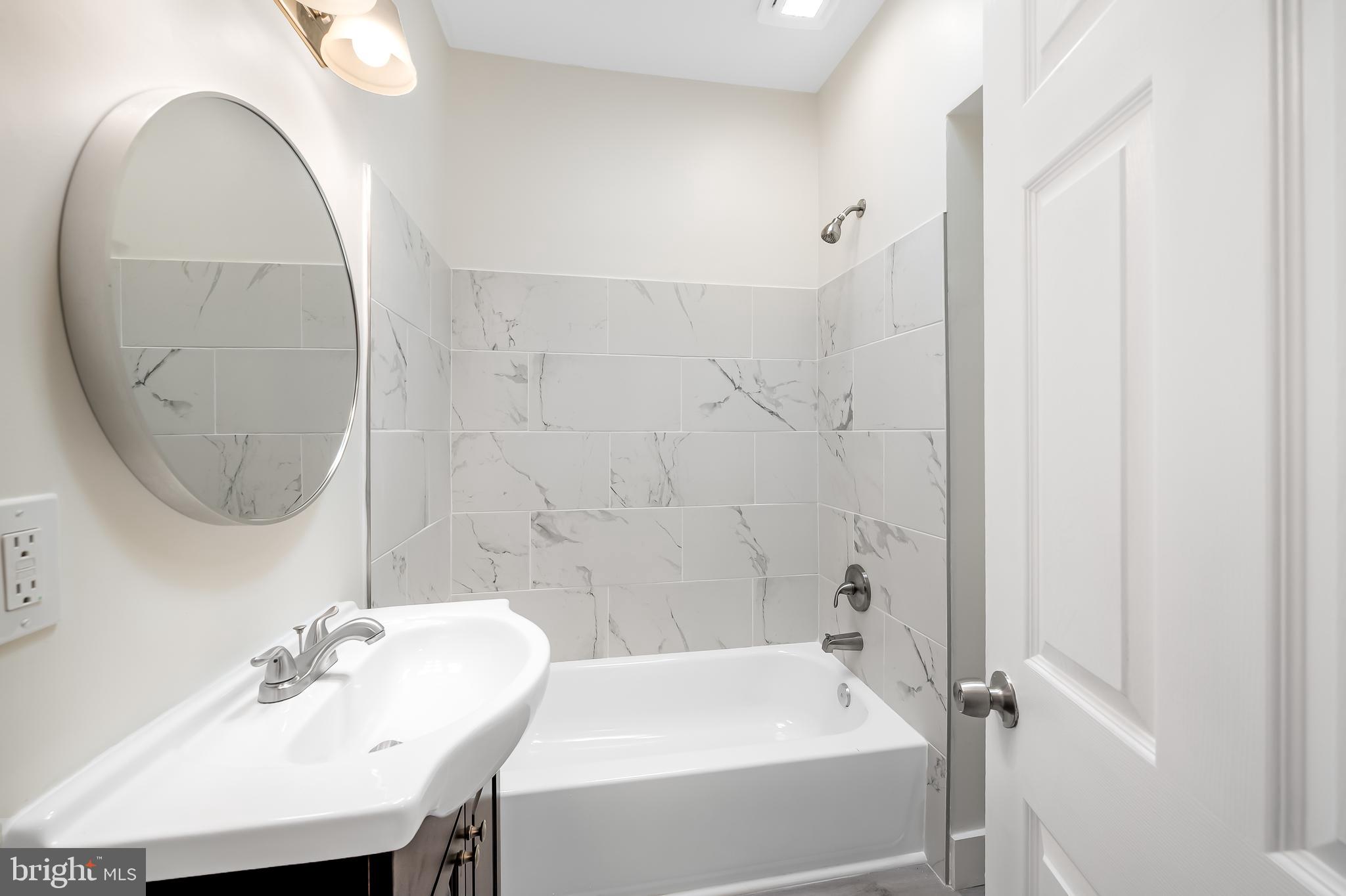 3003 Kentucky Avenue Baltimore, MD 21213 - Photo 27 of 32 a bathroom with a sink and a mirror