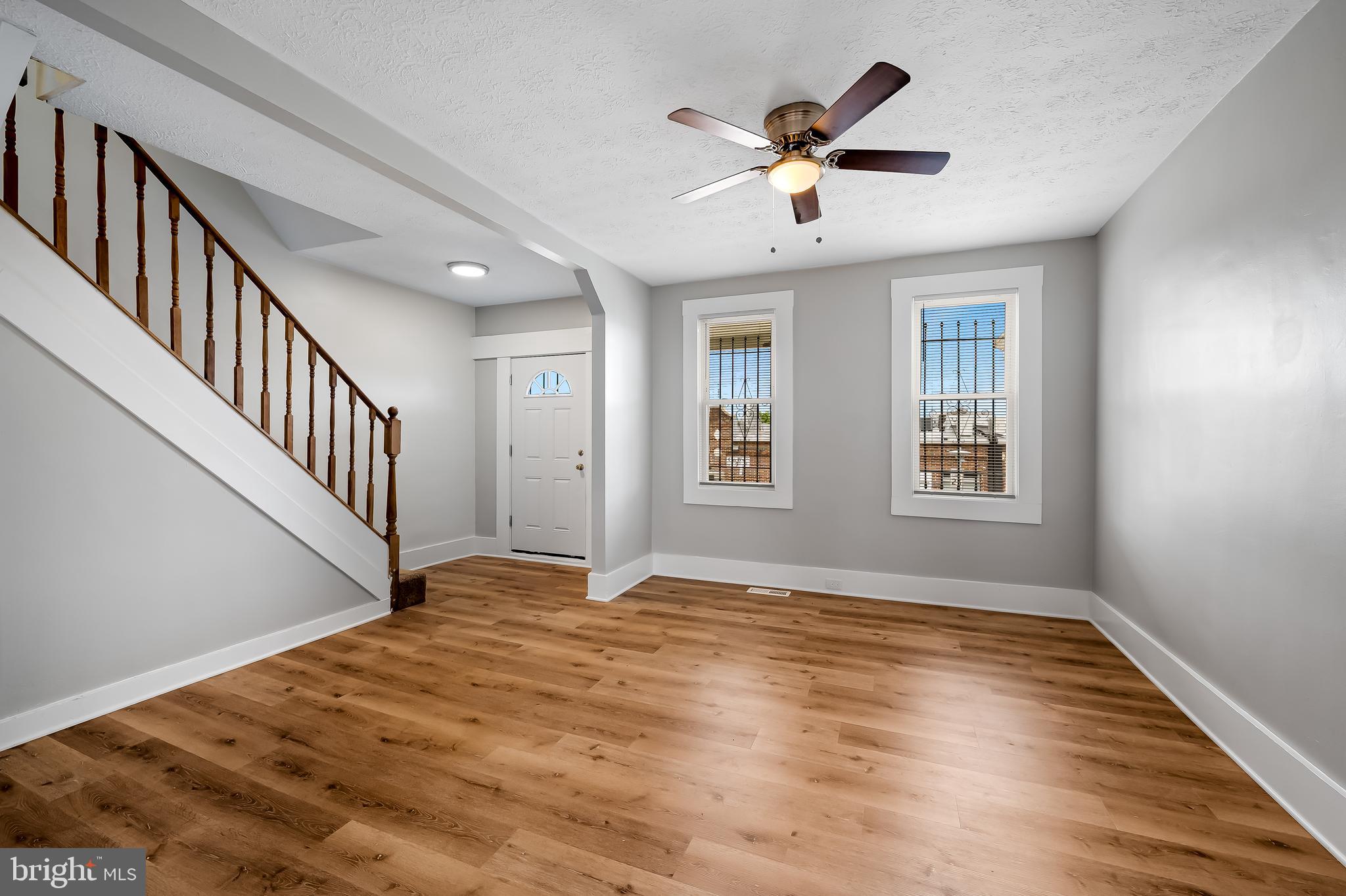 3003 Kentucky Avenue Baltimore, MD 21213 - Photo 5 of 32 a view of an empty room with wooden floor and a window
