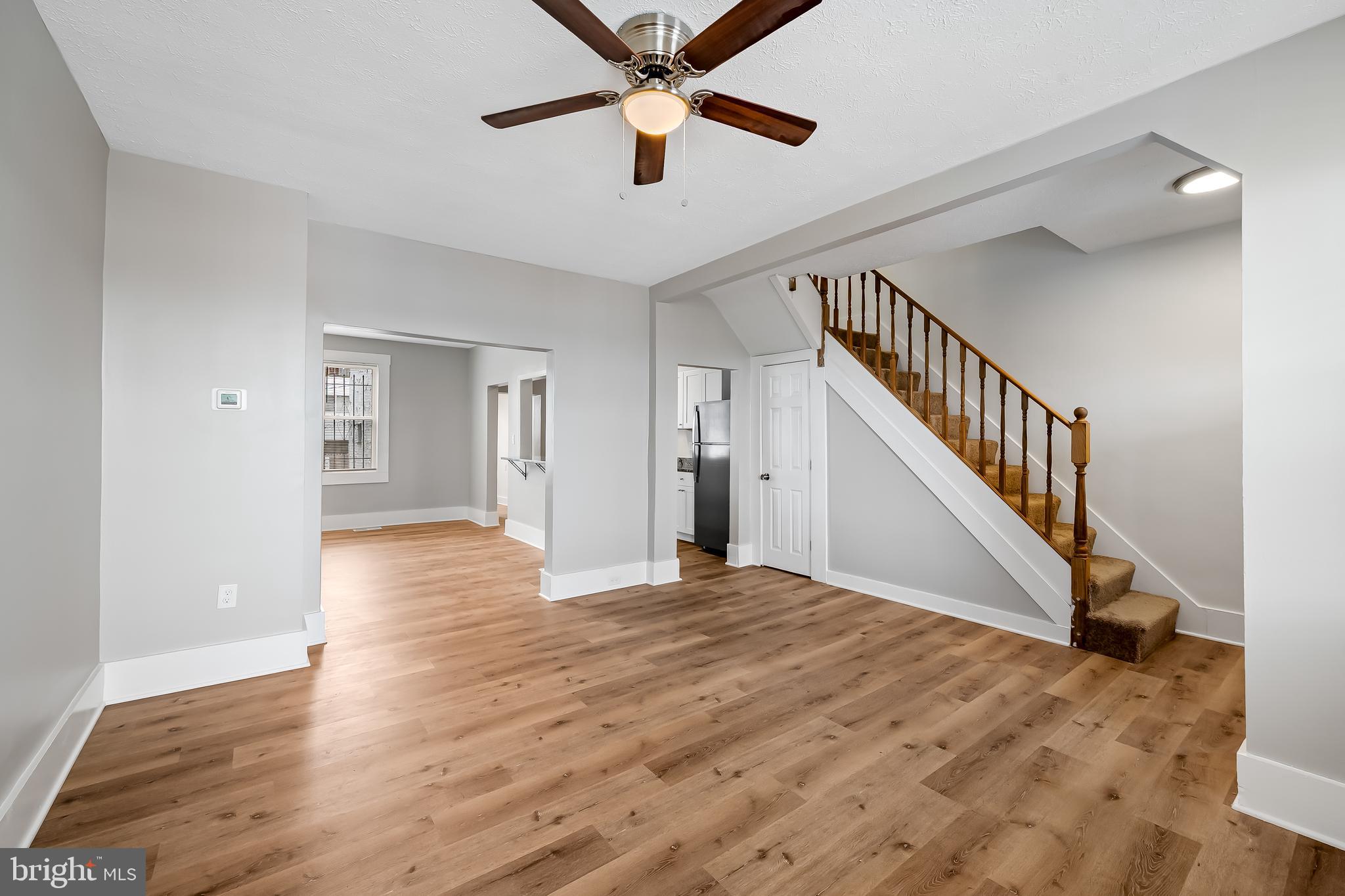 3003 Kentucky Avenue Baltimore, MD 21213 - Photo 7 of 32 a view of an empty room with wooden floor and a ceiling fan