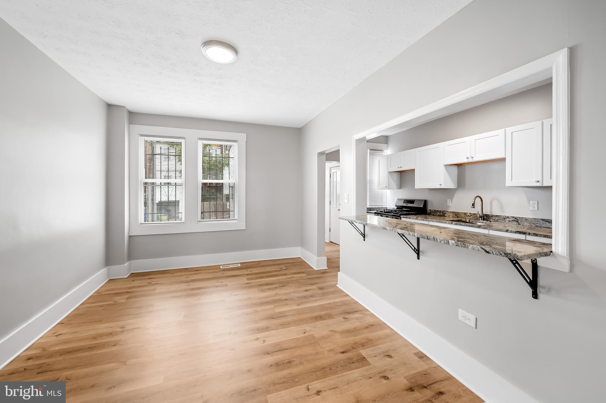 3003 Kentucky Avenue Baltimore, MD 21213 - Photo 9 of 32 a kitchen with a refrigerator and windows