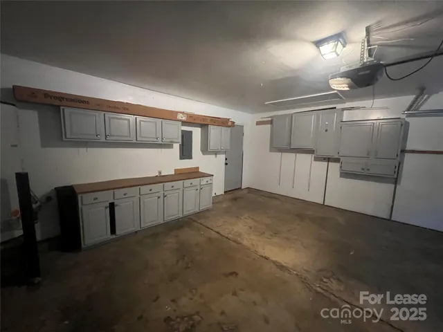a kitchen with cabinets and wooden floor