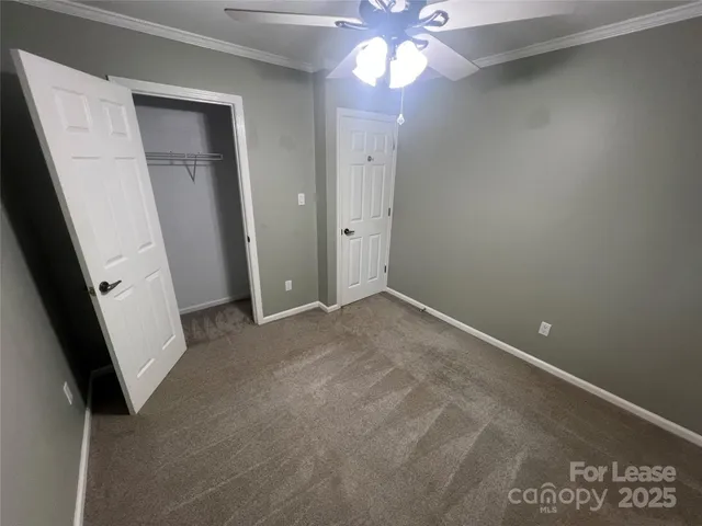 an empty room with a ceiling fan and hardwood floor