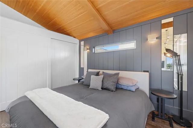 a bedroom with a bed and cabinets