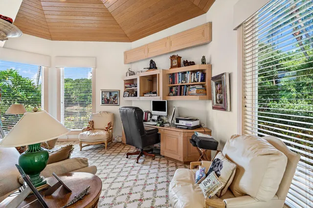 a living room with furniture and a open kitchen view