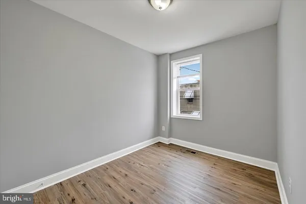 a view of a room with wooden floor and windows
