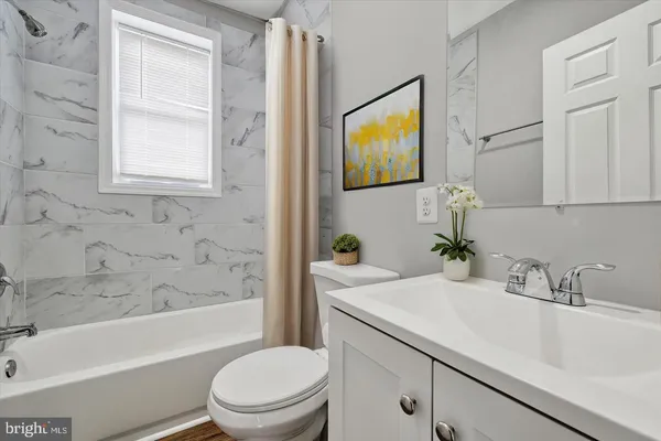 a bathroom with a sink a toilet and a bathtub