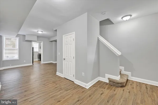 a view of an empty room and wooden floor
