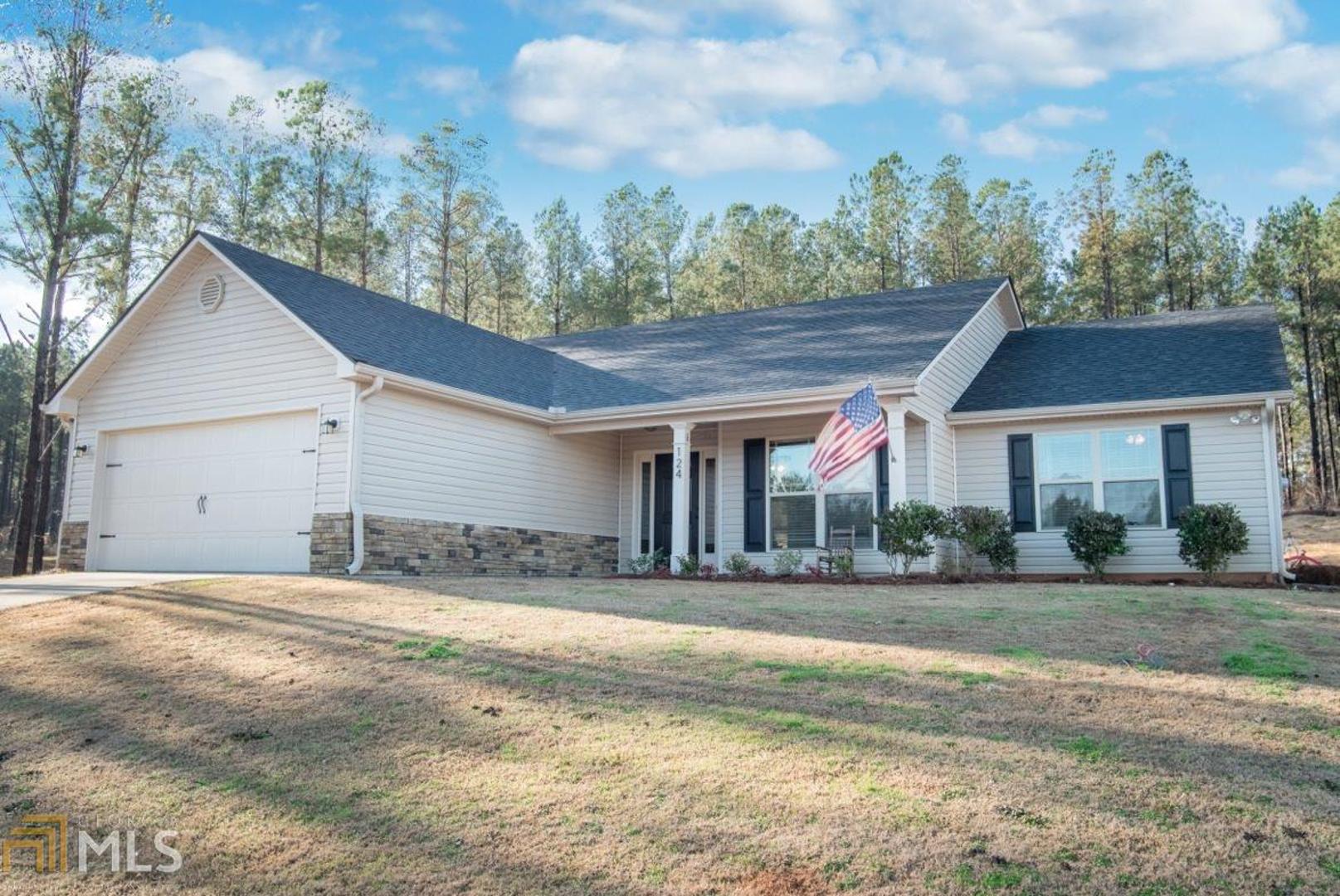 a view of a house with a yard and plants
