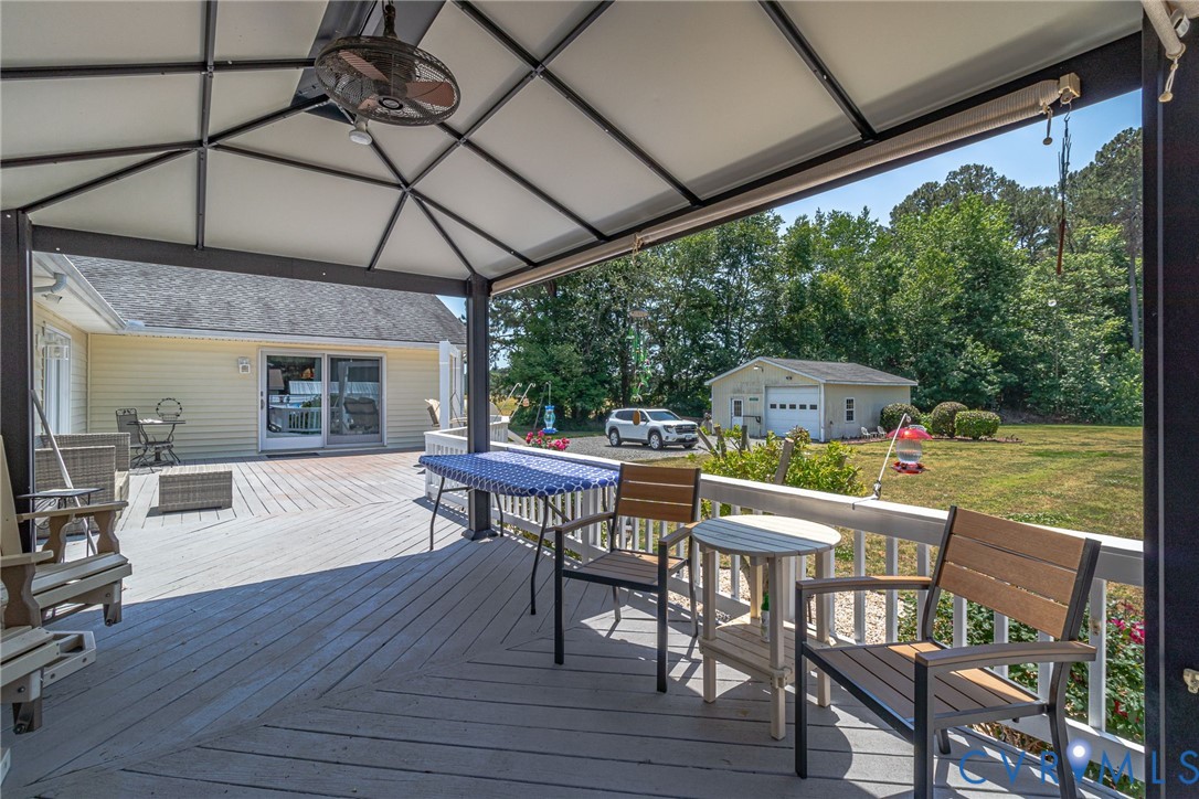 4400 Hacks Neck Road Heathsville, VA 22473 - Photo 58 of 78 a view of a patio with table and chairs under an umbrella