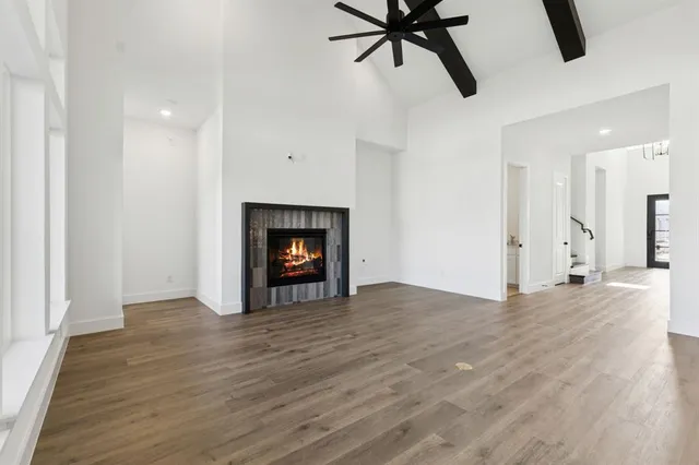a view of an empty room with a fireplace and a window