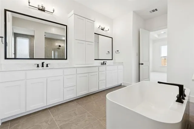 a bathroom with a double vanity sink mirror and