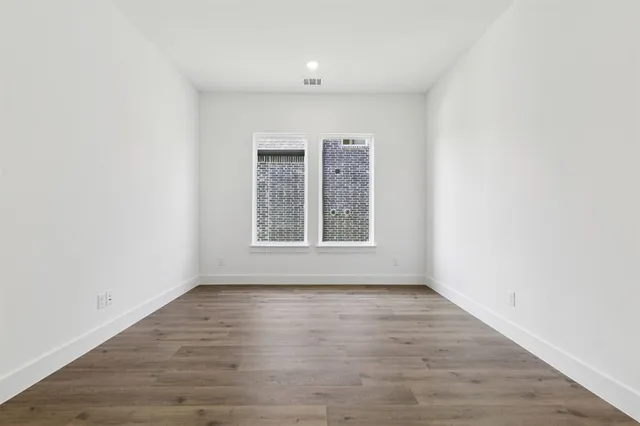 a kitchen with stainless steel appliances granite countertop a sink a stove and a wooden floors