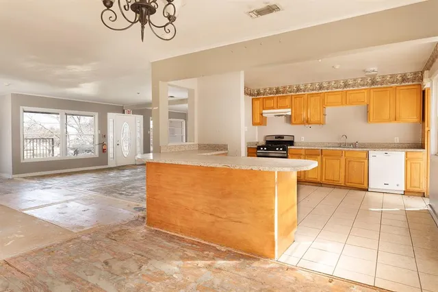 a view of a livingroom with wooden floor and a chandelier