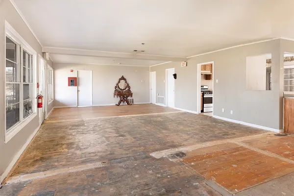 a view of a livingroom with wooden floor and a window