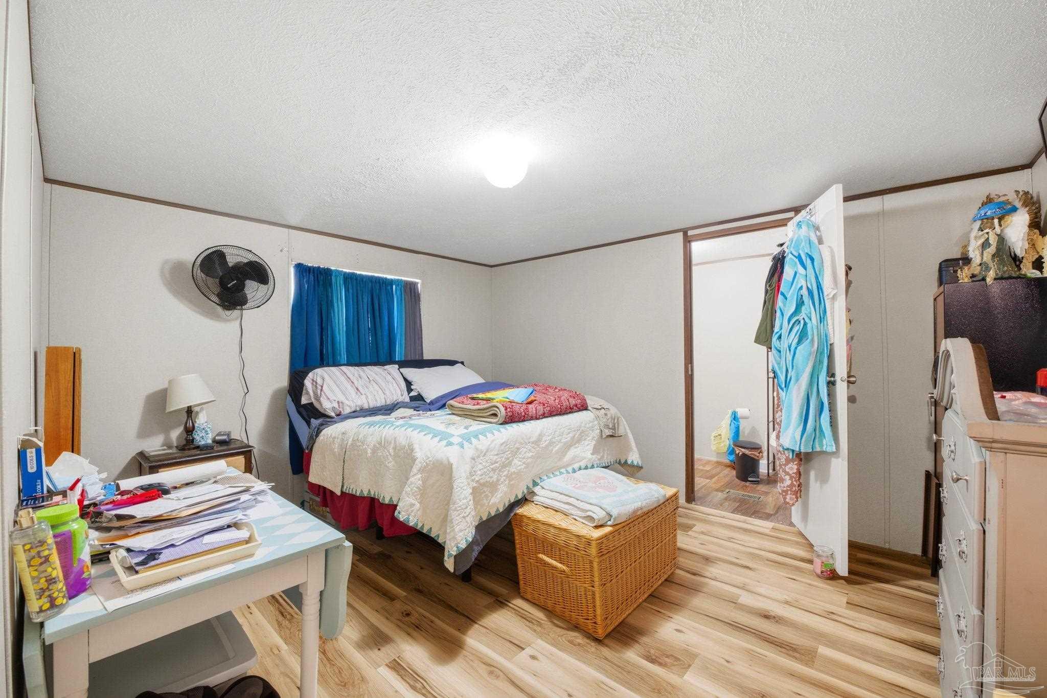 3338 Bob Tolbert Road Navarre, FL 32566 - Photo 11 of 29 a bedroom with a bed and a desk