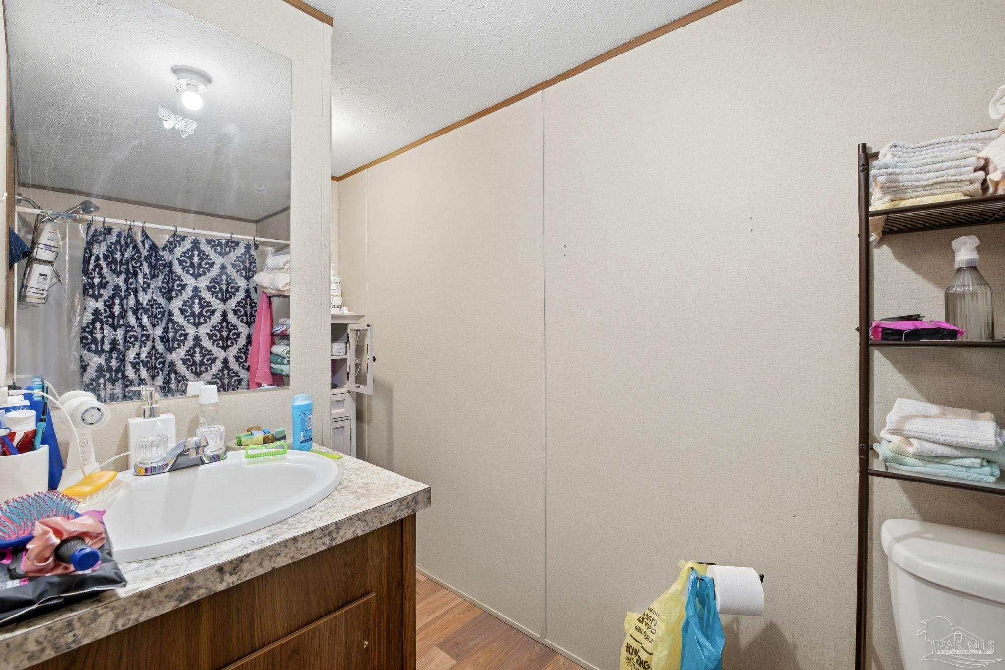 3338 Bob Tolbert Road Navarre, FL 32566 - Photo 15 of 29 a bathroom with a sink and a mirror