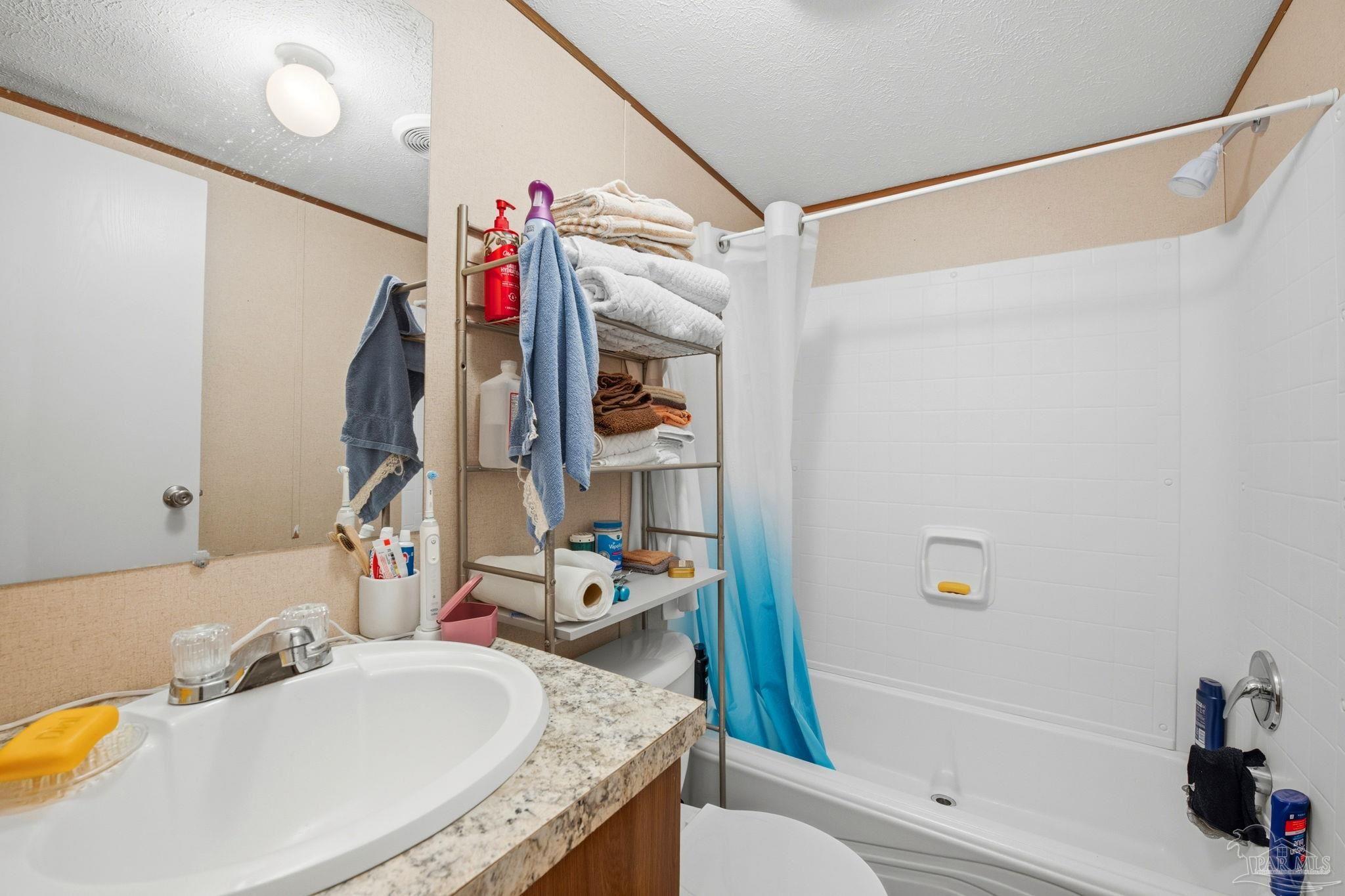3338 Bob Tolbert Road Navarre, FL 32566 - Photo 19 of 29 a bathroom with a granite countertop tub sink and a mirror