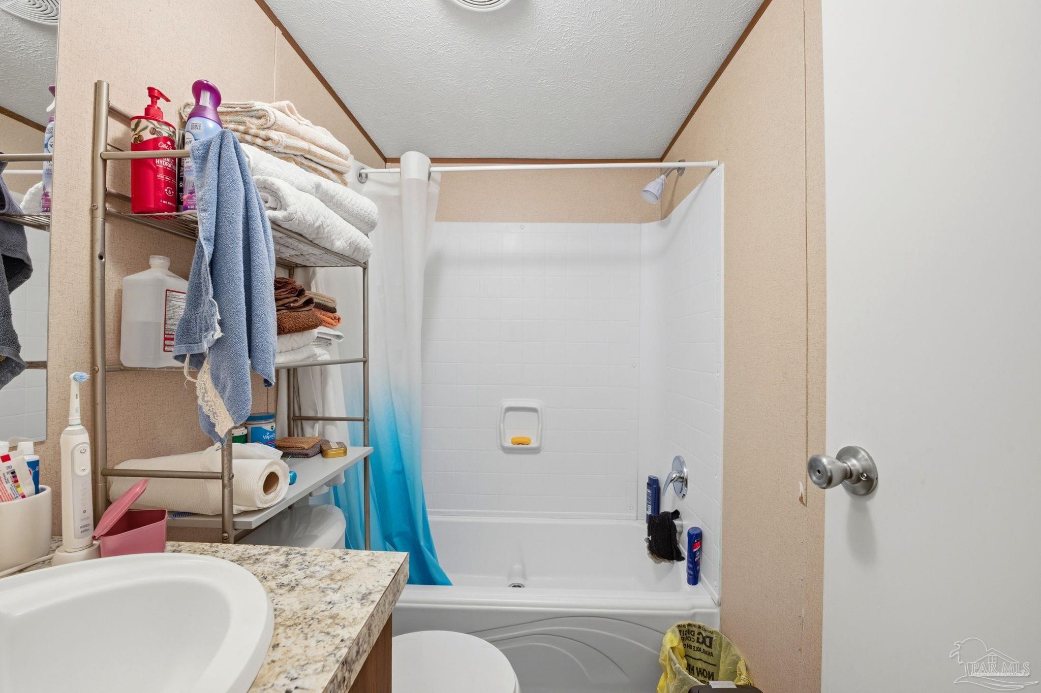 3338 Bob Tolbert Road Navarre, FL 32566 - Photo 20 of 29 a bathroom with a granite countertop bathtub shower and a sink
