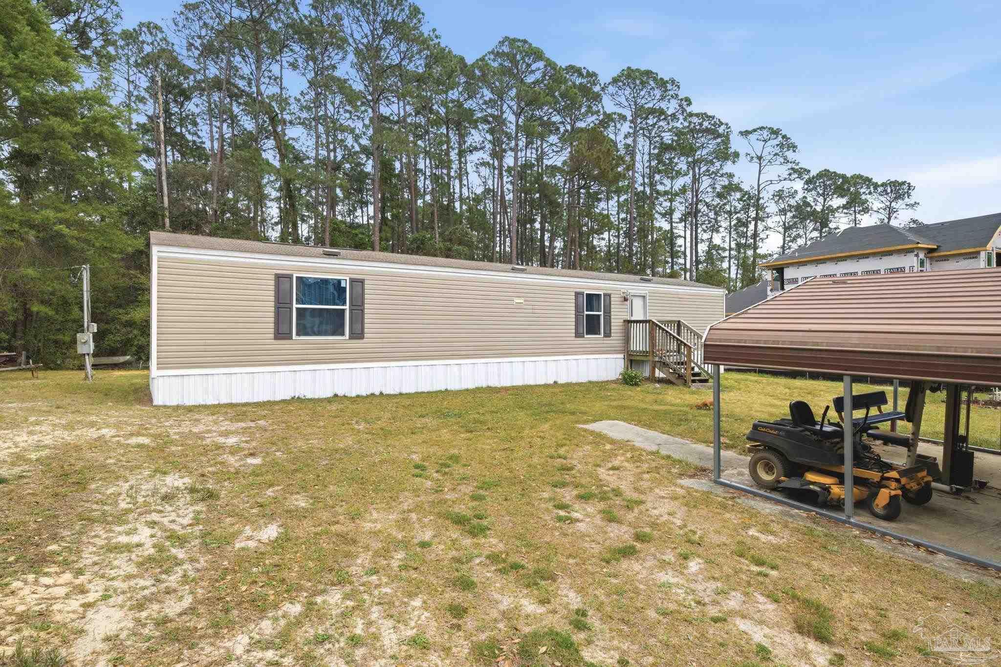 3338 Bob Tolbert Road Navarre, FL 32566 - Photo 2 of 29 a view of a house with backyard porch and sitting area
