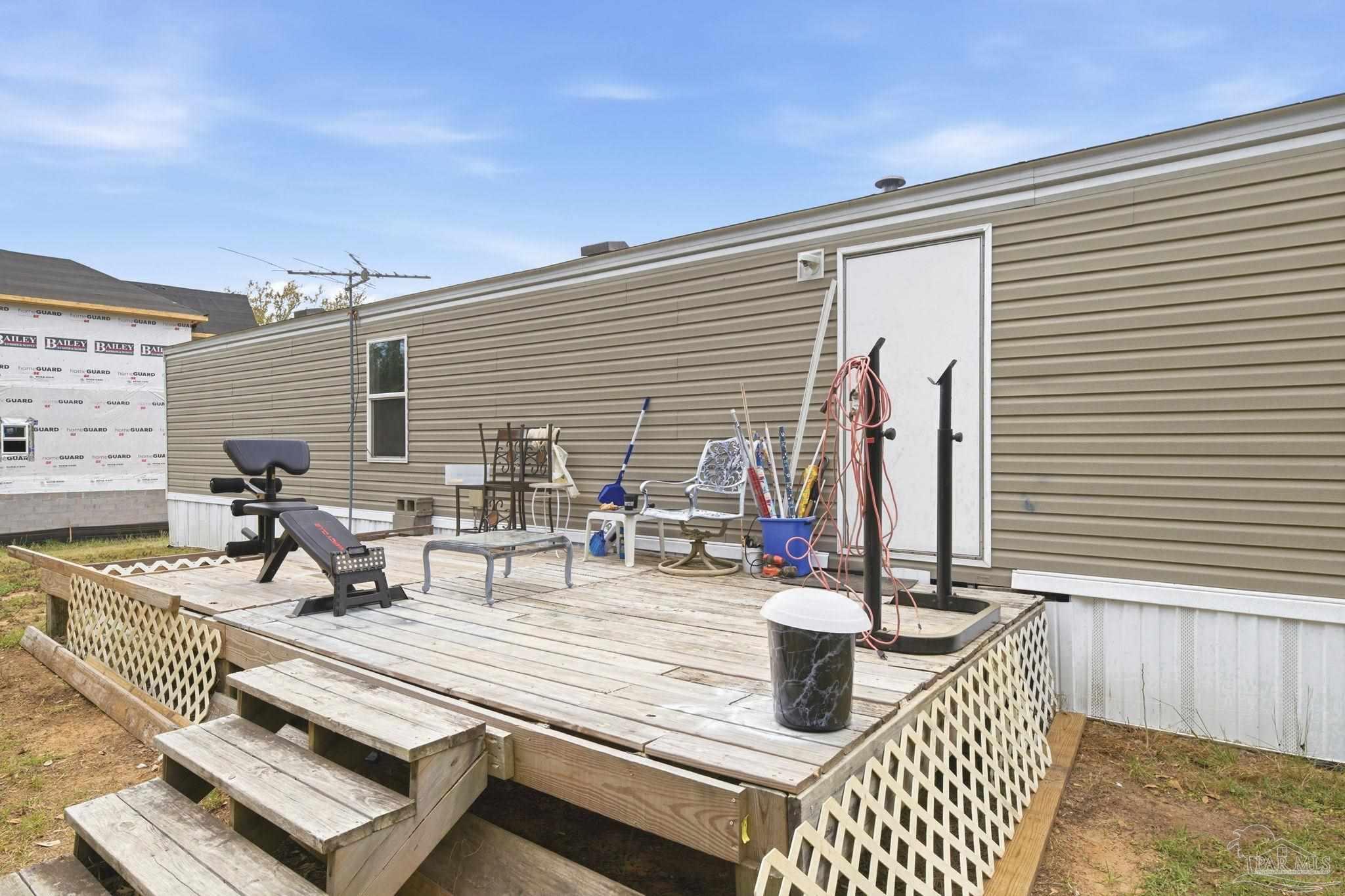 3338 Bob Tolbert Road Navarre, FL 32566 - Photo 22 of 29 a view of a patio with couches and potted plants