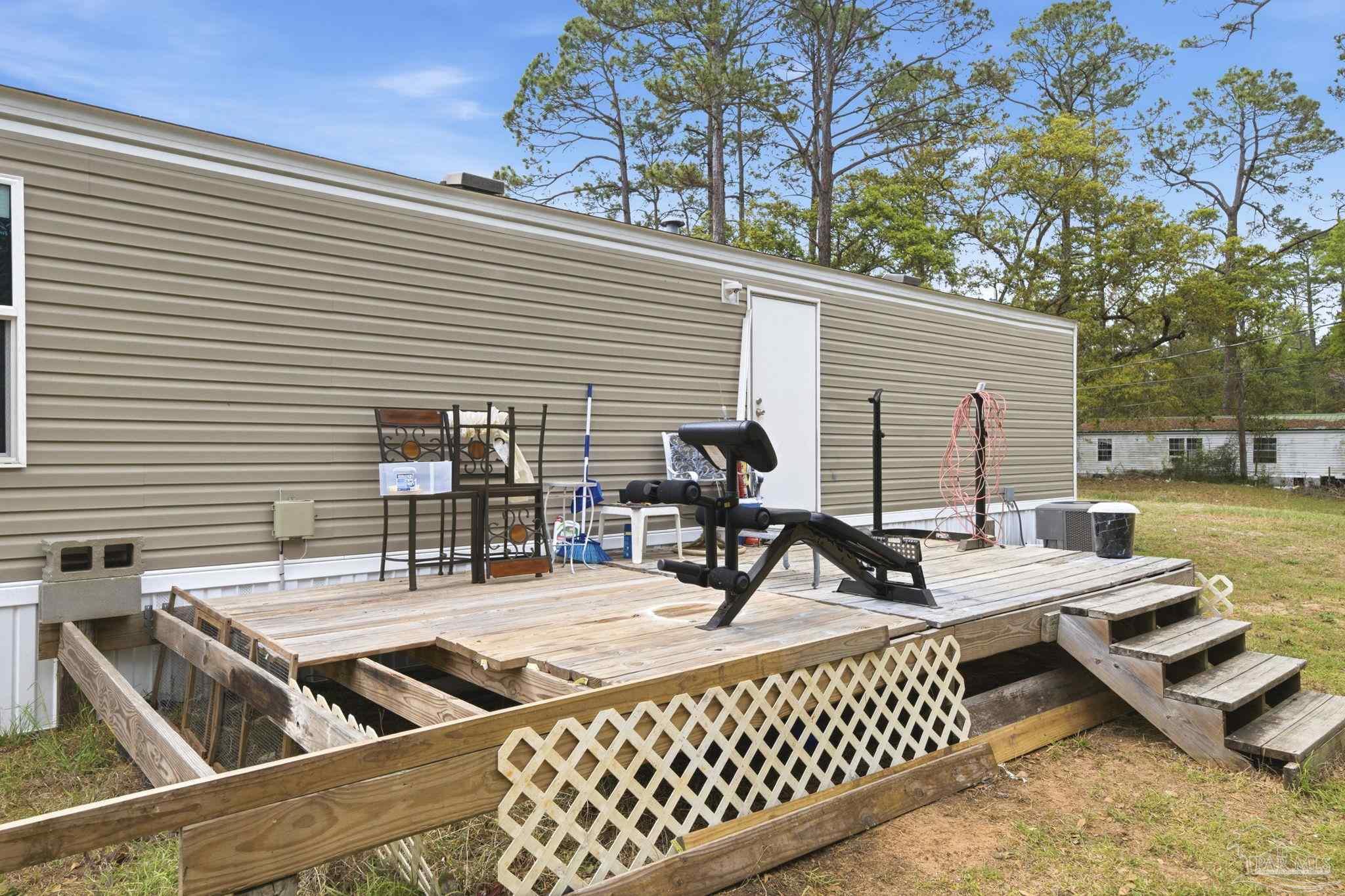 3338 Bob Tolbert Road Navarre, FL 32566 - Photo 23 of 29 a view of a roof deck with couches and chairs