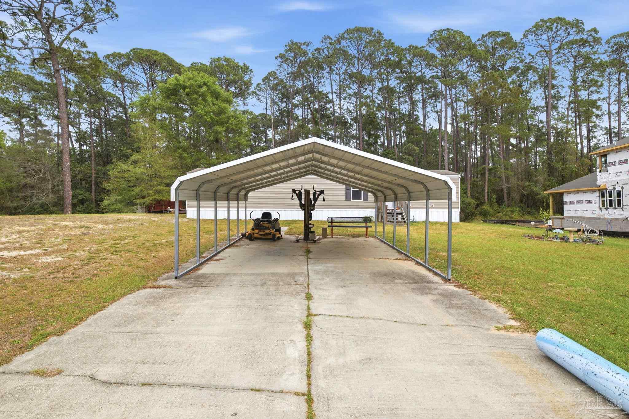 3338 Bob Tolbert Road Navarre, FL 32566 - Photo 28 of 29 a view of a swimming pool with a patio