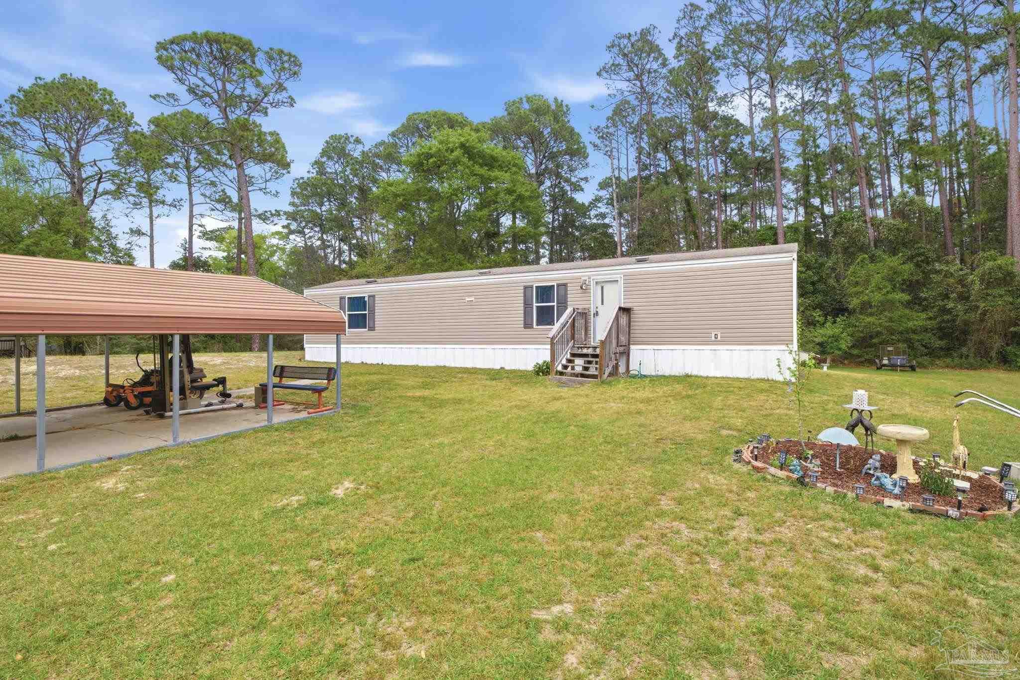 3338 Bob Tolbert Road Navarre, FL 32566 - Photo 3 of 29 a view of a swimming pool with a patio