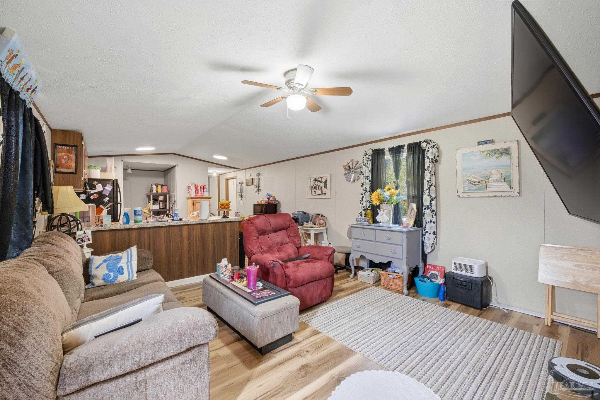 3338 Bob Tolbert Road Navarre, FL 32566 - Photo 5 of 29 a living room with furniture and a view of kitchen