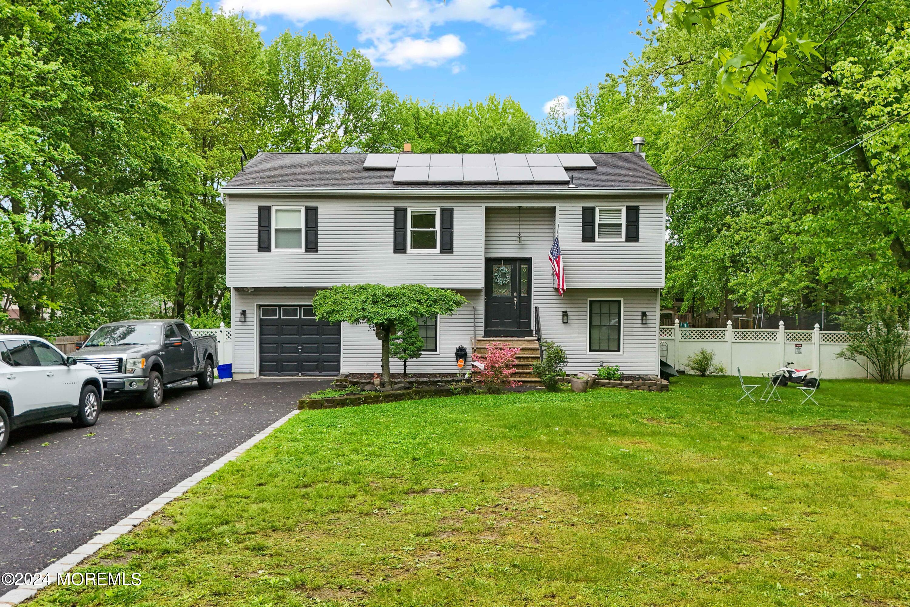 429 Cottrell Road Matawan, NJ 07747 - Photo 1 of 22 a view of a house with a yard and sitting area