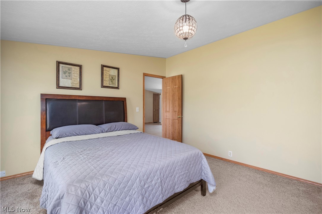 294 Twp 150 Road Sullivan, OH 44880 - Photo 26 of 39 Carpeted bedroom with a bead-board ceiling and warm-toned wall paint