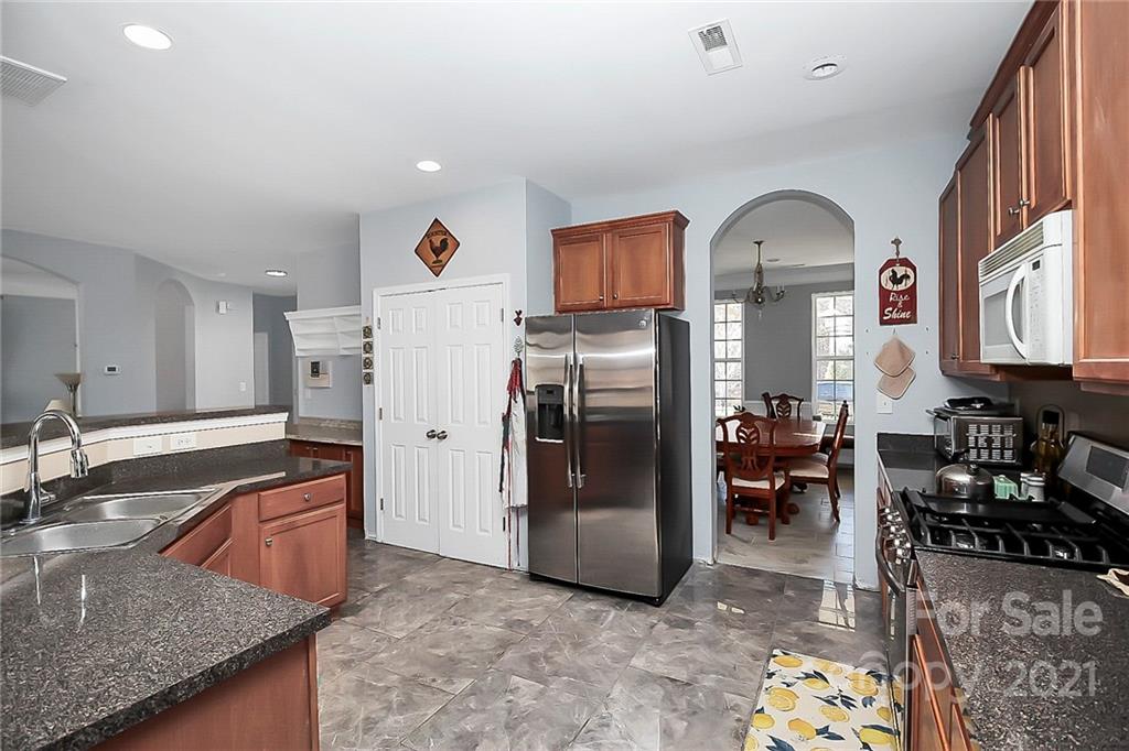 7769 East Berkeley Road Denver, NC 28037 - Photo 11 of 31 a kitchen with refrigerator and countertop