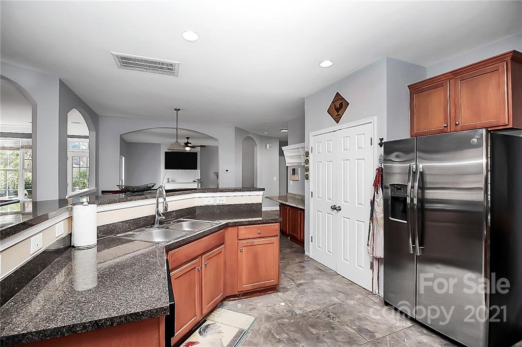 7769 East Berkeley Road Denver, NC 28037 - Photo 12 of 31 a kitchen with stainless steel appliances granite countertop a sink stove and refrigerator