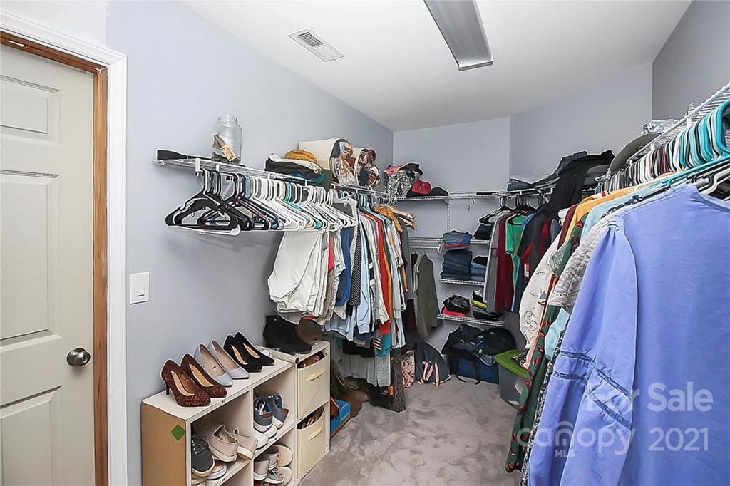 7769 East Berkeley Road Denver, NC 28037 - Photo 19 of 31 a view of walk in closet with clothes and shoes