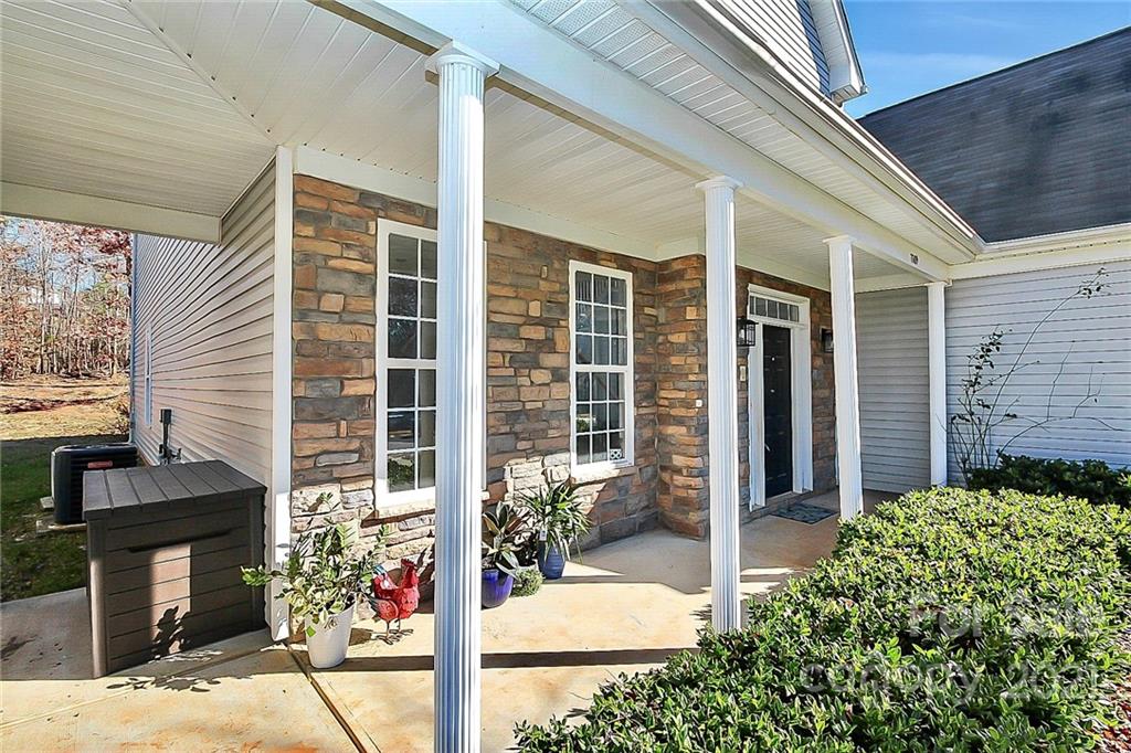 7769 East Berkeley Road Denver, NC 28037 - Photo 3 of 31 a front view of a house with a garden