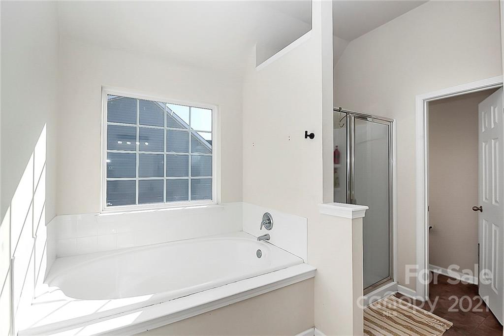 7769 East Berkeley Road Denver, NC 28037 - Photo 21 of 31 a bathroom with a bathtub and a window