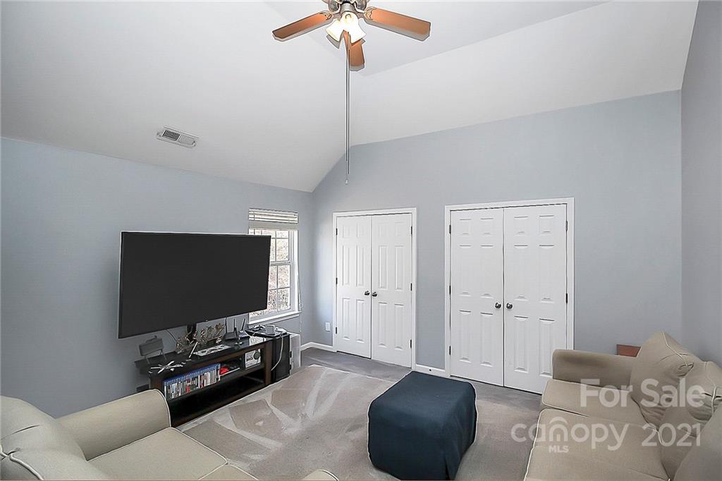 7769 East Berkeley Road Denver, NC 28037 - Photo 22 of 31 a living room with furniture and a flat screen tv