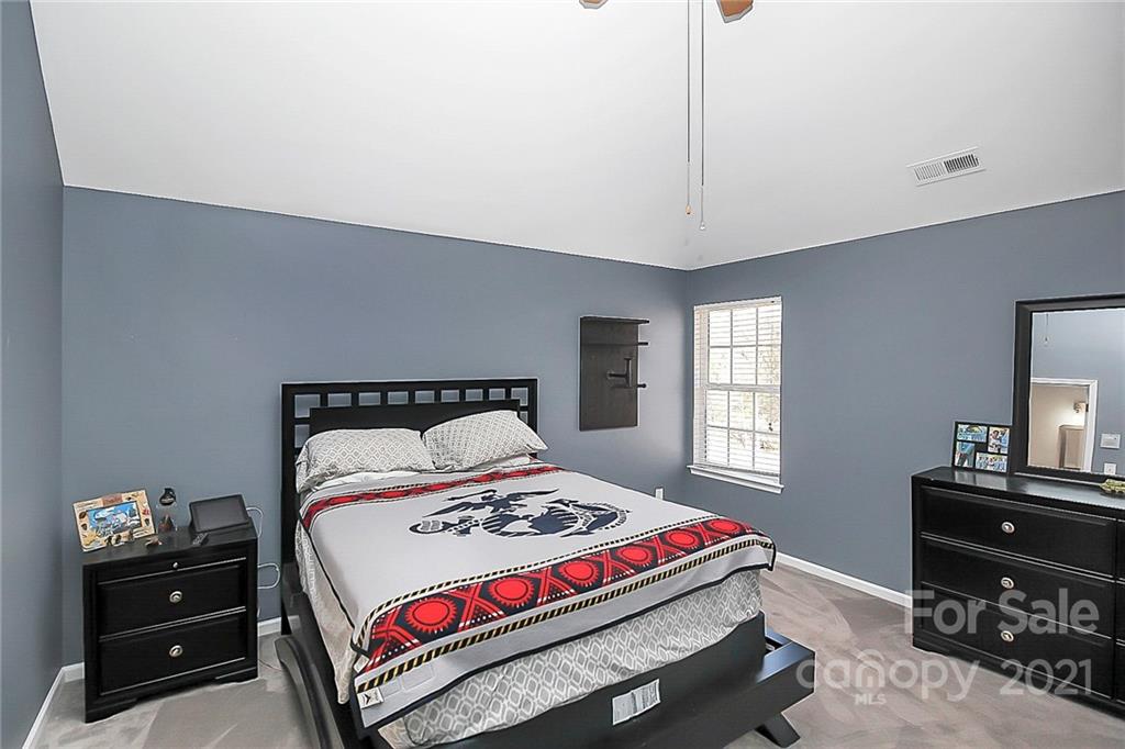 7769 East Berkeley Road Denver, NC 28037 - Photo 24 of 31 a bedroom with a bed and a dresser