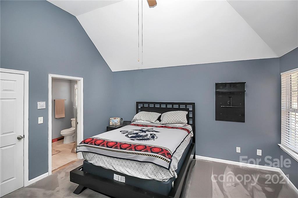 7769 East Berkeley Road Denver, NC 28037 - Photo 25 of 31 a bedroom with a bed and a lamp on dresser