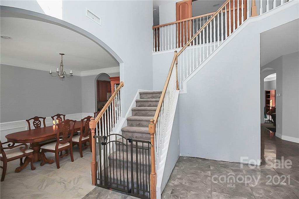 7769 East Berkeley Road Denver, NC 28037 - Photo 4 of 31 a view of a hallway with stairs and furniture