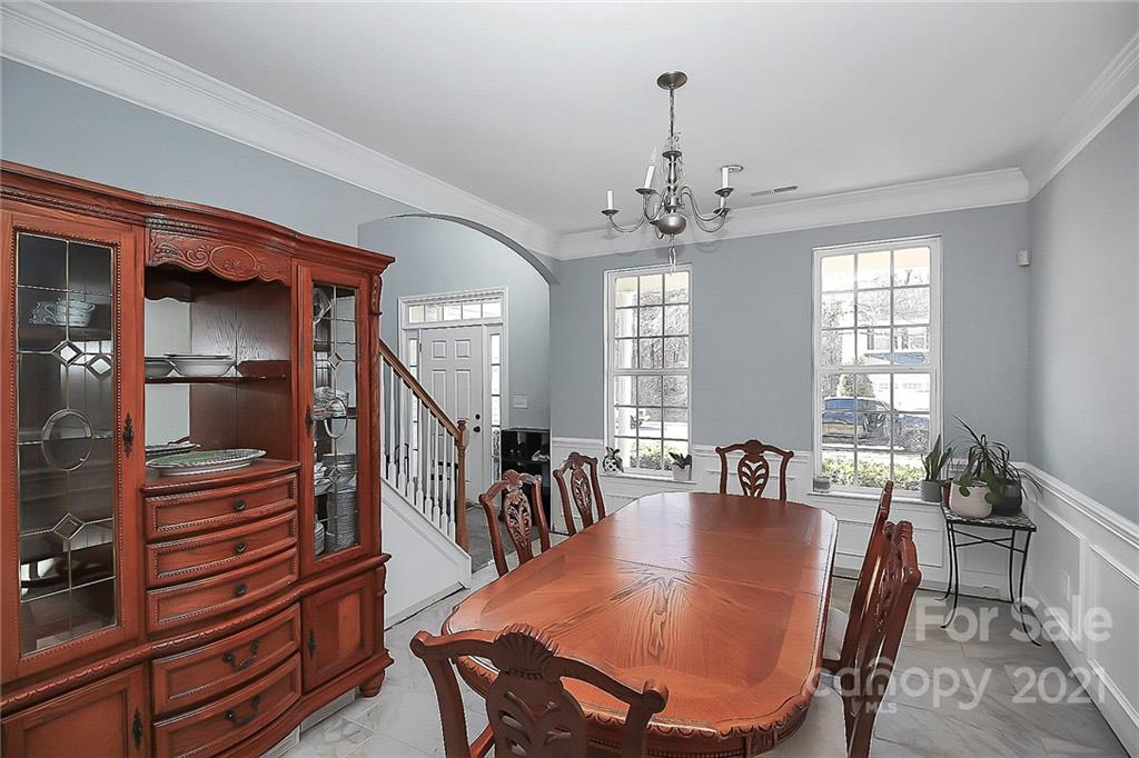 7769 East Berkeley Road Denver, NC 28037 - Photo 5 of 31 a dining room with furniture a chandelier and wooden floor