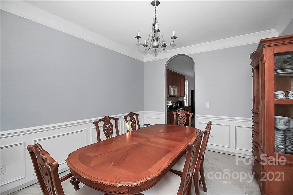 7769 East Berkeley Road Denver, NC 28037 - Photo 7 of 31 a view of a dining room with furniture and chandelier